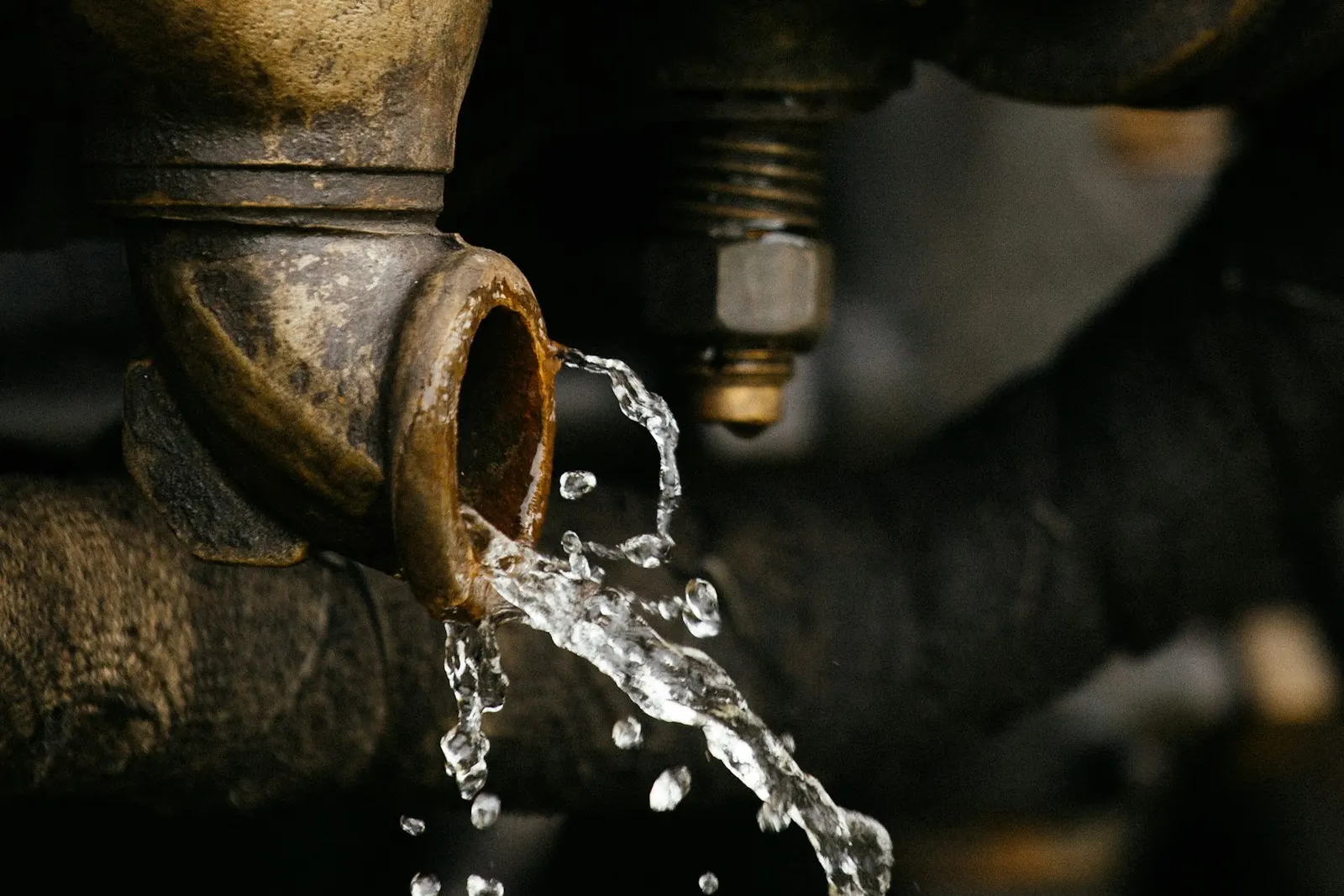 Water spraying from a leaking pipe fitting
