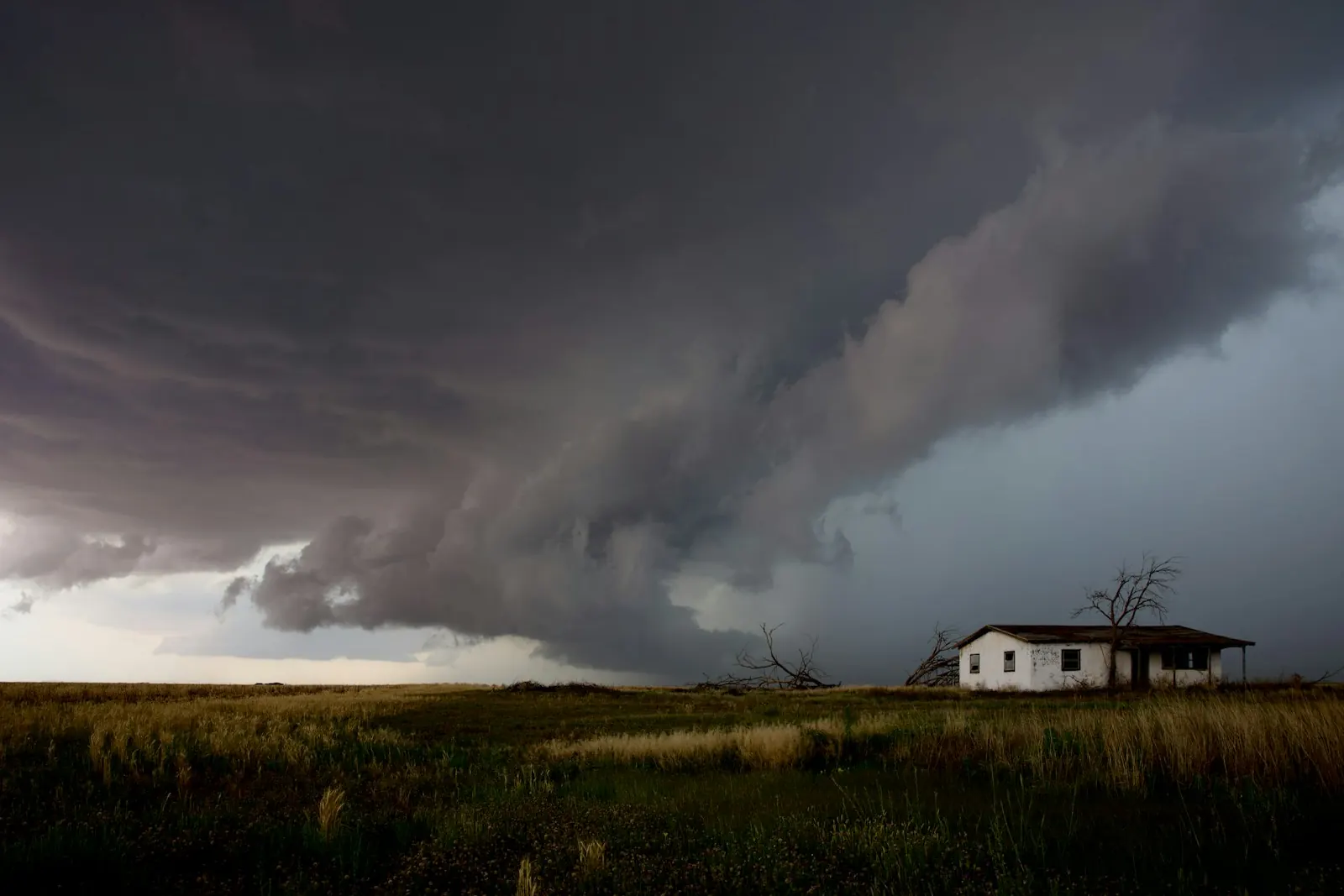 Storm clouds rolling in over a house on the North Texas plains